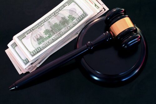 stack of money next to a gavel