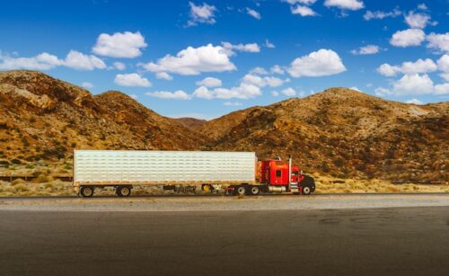 truck driving past mountains