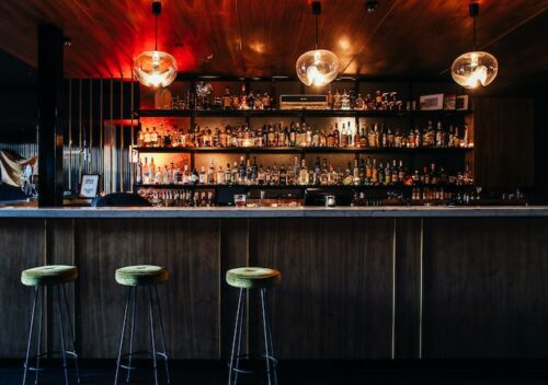 inside of bar with bottles on wall