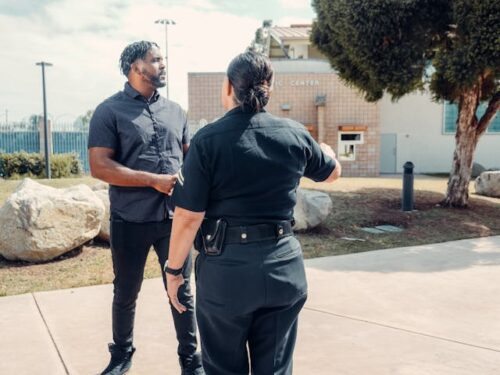 person talking to police officer