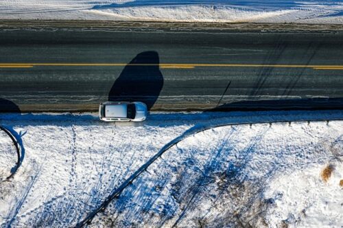 car on side of road with snow