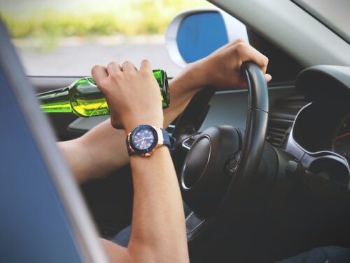 driver drinking a beer behind the wheel